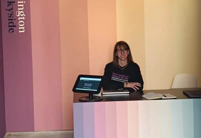 Giulia Naspi at the front desk of the Aotearoa New Zealand Pavilion at the Venie Biennale. Image supplied